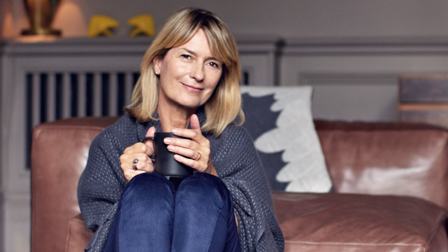 Woman drinking hot coffee in her sofa