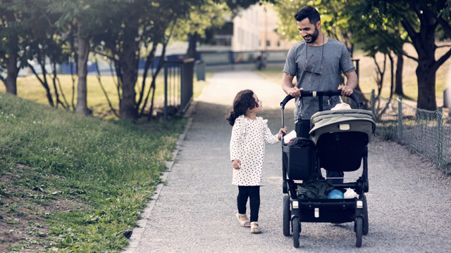 Man walking with kid and a stroller