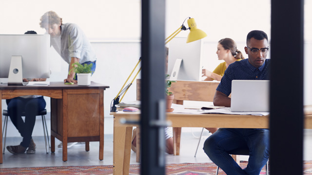 Office community with four persons working