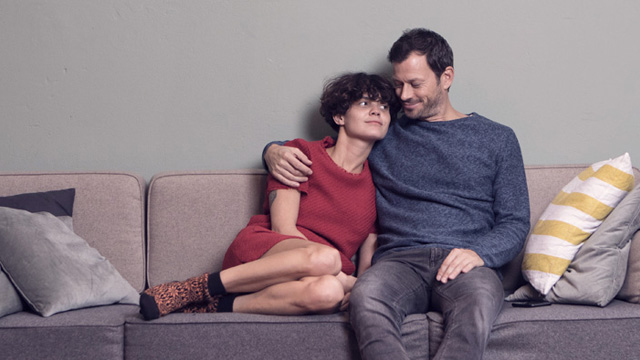 Couple sitting close to each other in a sofa