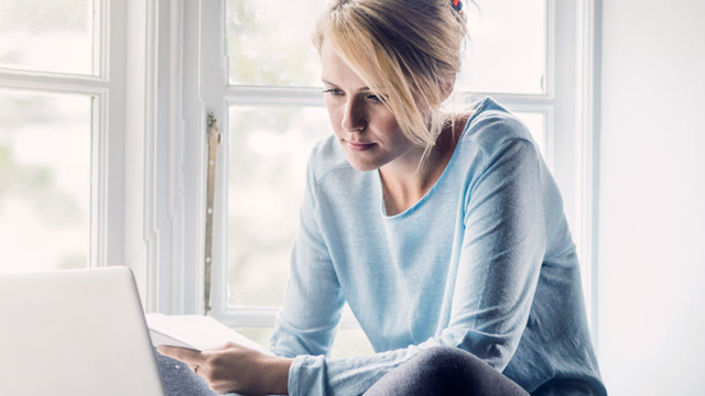 Woman in window with laptop