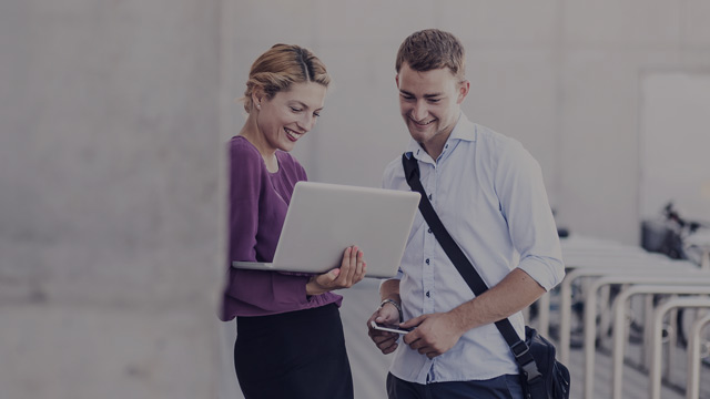 Couple looking at laptop small overlay