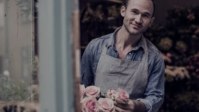 Male florist in flower shop small overlay