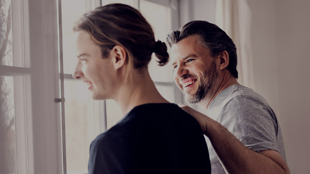 two men in front of window small overlay