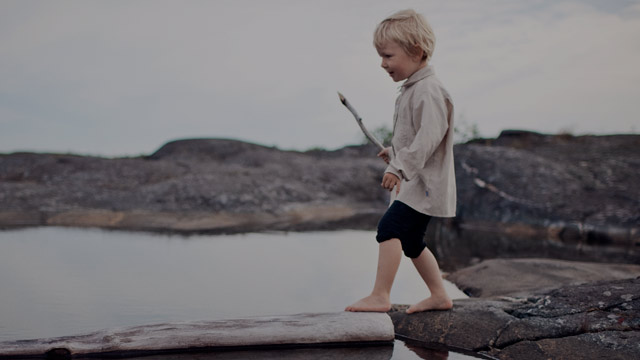 boy playing by water small overlay