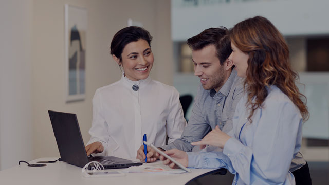 colleagues working in front of desk small overlay