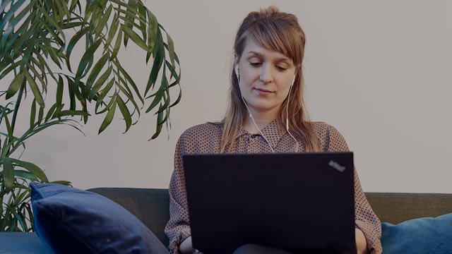 young woman with laptop in living room small overlay