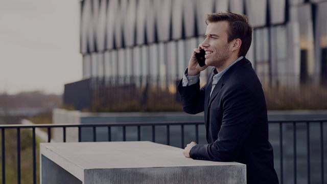 young man outside talking on the phone small overlay