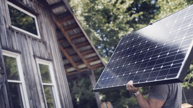 Man carrying a solar panel