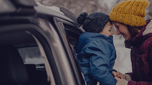 mother and child by car