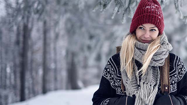 Mid adult woman with backpack in forest small