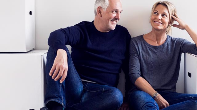 Couple sitting next to moving boxes - small