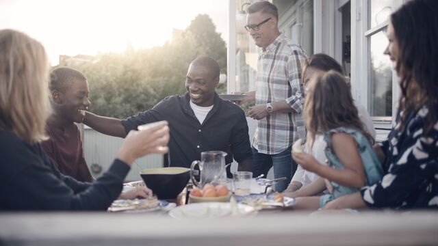 Cheerful-multi-generation-family-enjoying-lunch-at-porch-small