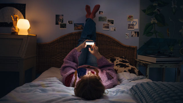 Teenager-in-bed-with-mobile-small